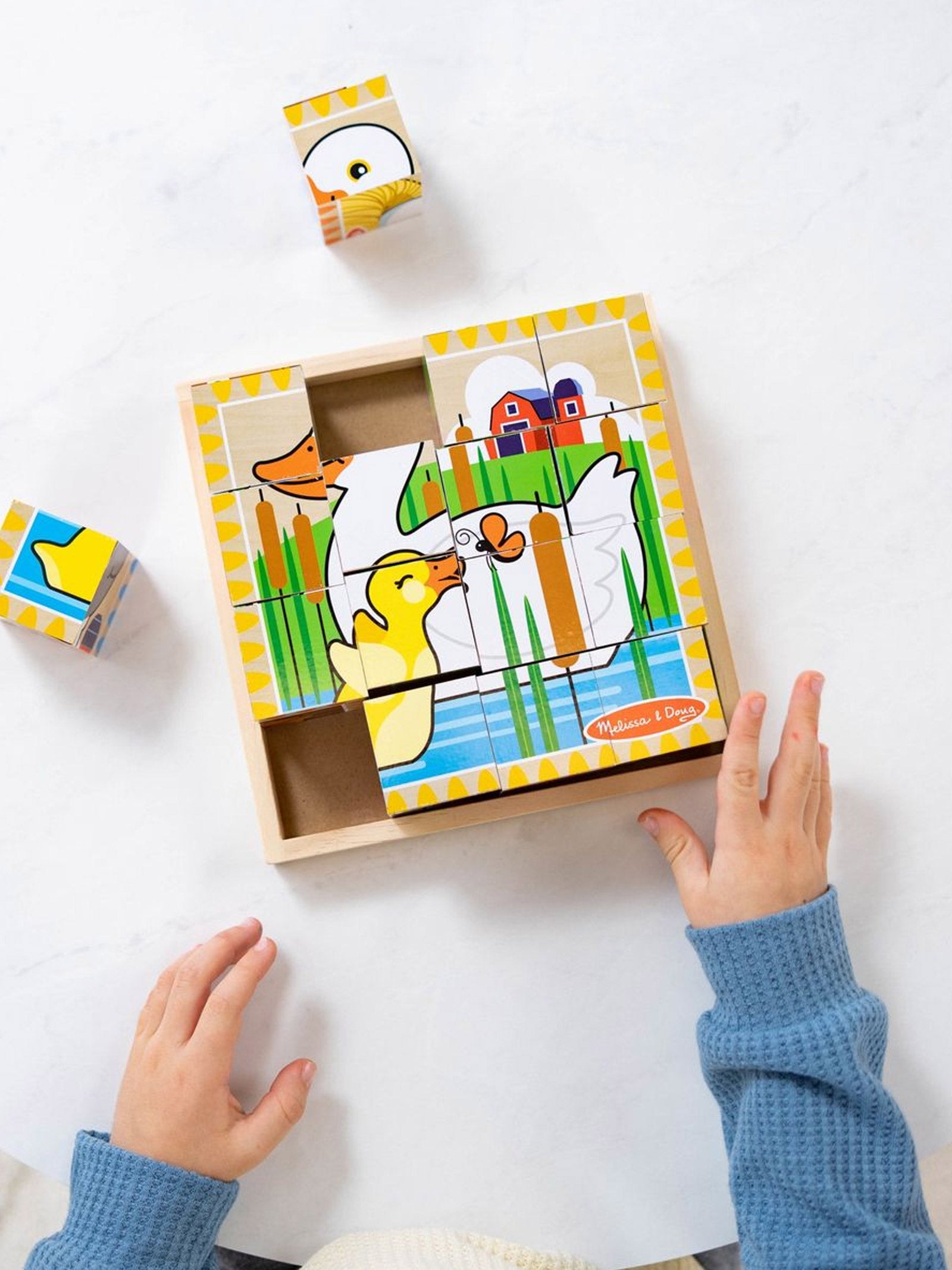 Children's wooden puzzle with a duck design on a white surface